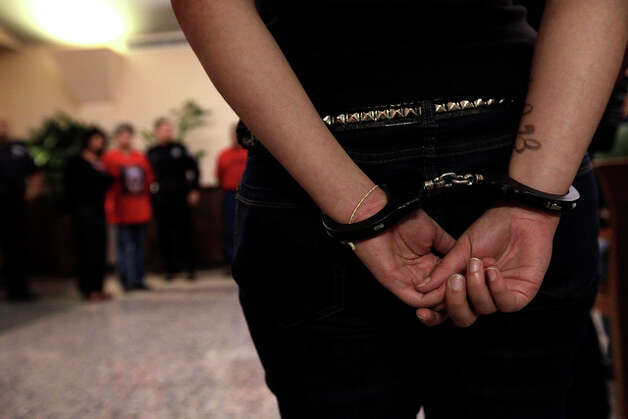 DREAM Act supporters are handcuffed after they are arrested