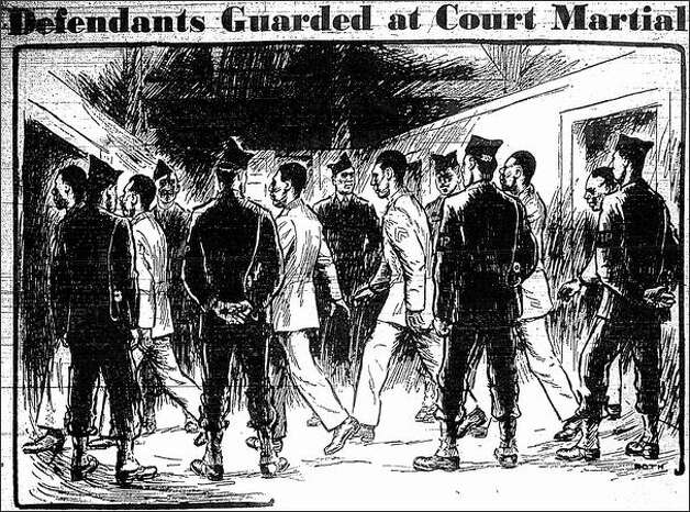 Published Dec. 12, 1944: This parade is repeated half a dozen times a day at Fort Lawton, where 41 Negro soldiers are on trial on the charge of staging a riot last August, in which a former Italian prisoner of war was killed and dozens were severely injured. In this sketch, made on the scene, Henry Roth, Post-Intelligencer staff artist, shows the Negroes marching in single file, between two lines of husky white military policemen, from their waiting room into the courtroom. The same procedure is followed in reverse whenever they leave the courtroom for a recess or when the court-martial adjourns for the evening. The M. P.s, easily distinguishable by the garrison caps which they keep on their heads at all times, their brassards and white leggings and the white lanyards on their pistols, remain on guard during all sessions. Photo: Seattle Post-Intelligencer / SL
