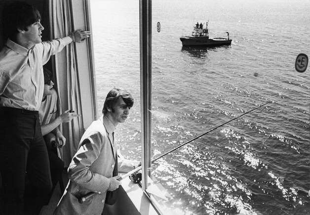 Ringo Starr fishes out an Edgewater Hotel window in Aug. 1964. Paul McCartney, left, and John Lennon watch. (William Lovelace/Express Newspapers/Getty Images) Photo: Getty Images
