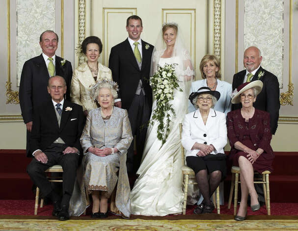 This image released by the family shows the wedding group of Peter Phillips, top center left, and his bride Autumn Kelly, top center right, at Frogmore House, Windsor Castle, England and (seated left to right front row) Prince Philip, Queen Elizabeth II, Ivy Kelly, Edith McCarthy, (standing left to right) Mark Phillips, Princess Anne, Kity Kelly, Brian Kelly. (AP Photo/Sir Geoffrey Shakerley, HO)