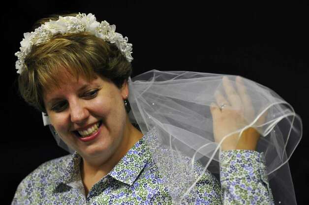 Lisa Witkowski wears the bridal veil from her 1994 wedding while