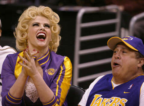 Smith and Danny DeVito clown around during a Los Angeles Lakers' game in 2004. Photo: CHRIS CARLSON, Associated Press