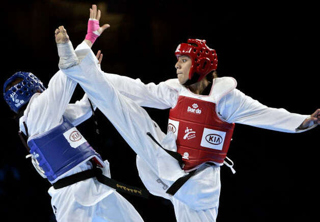 Sugar Land's Diana Lopez, right, will join brothers Mark and Steven on the 2008 USA Olympic Taekwondo team. Photo: MANU FERNANDEZ, AP / HC
