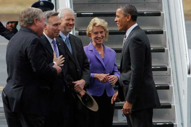 Seattle Mayor Mike McGinn and Gov. Chris Gregoire are all smiles as they greet President Obama at Boeing Field in 2011.  Appearances deceive.  