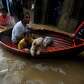 Residents ride a boat as they evacuate a flooded area during.... photo: 1630332 slideshow 31095