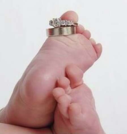  late husband's wedding ring on their 4month old daughter's foot