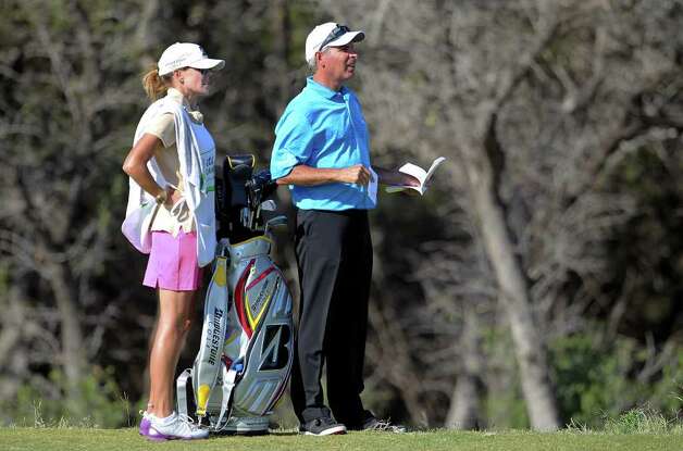 Fred Couples studies the fairway with his caddie Midge Trammell during the 