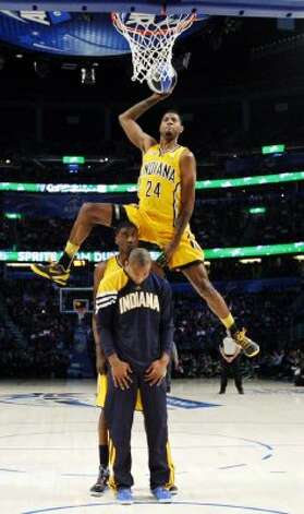 Indiana Pacers' Paul George jumps over two teammates during the NBA basketball All-Star Slam Dunk Contest in Orlando, Fla. Saturday, Feb. 25, 2012. (AP Photo/Jeff Haynes, Pool) (AP) / SA