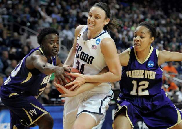 Prairie View A&M's Latia Williams, front, is guarded by Connecticut's Kelly Faris, back, during the first half of an NCAA tournament first-round college basketball game in Bridgeport, Conn., Saturday, March 17, 2012. (AP Photo/Jessica Hill) Photo: Jessica Hill, Associated Press / AP2012