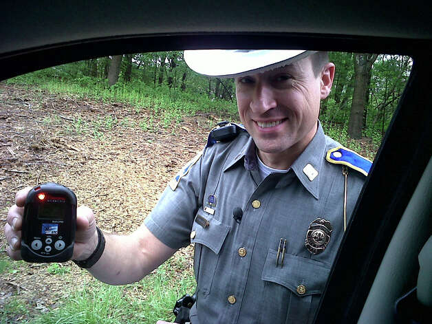 A Connecticut State Police trooper shows a radioactivity detector which is used to help identify potential terror threats. Mike Apatow of Milford was entering Interstate 84 in Newtown when he was pulled over by a trooper  who said Alpow flagged as a radioactive car. Thankfully, ApatowâÄôs doctor had given him a piece of paper documenting that heâÄôd had a medical procedure involving a small amount of radioactive material. Photo: Contributed Photo / Connecticut Post Contributed