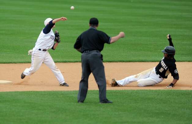 Staple's Benjamin Greenberg attempts a double play as Trumbull's Marcus Jenkins slides to second during the FCIAC baseball semifinals Thursday, May 24, 2012 at the Ballpark at Harbor Yard in Bridgeport, Conn. Photo: Autumn Driscoll / Connecticut Post