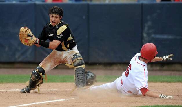 Greenwich's David Berdoff scores the team's only run as Trumbull catcher James DeNomme reaches to tag during Saturday's FCIAC baseball championship game at the Ballpark at Harbor Yard in Bridgeport on May 26, 2012. Photo: Lindsay Niegelberg / Stamford Advocate