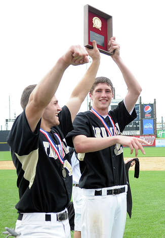 Trumbull's Brendan Moore, left, and Mike Yerina, right, hold up their team's trophy during Saturday's FCIAC baseball championship game at the Ballpark at Harbor Yard in Bridgeport on May 26, 2012. Photo: Lindsay Niegelberg / Stamford Advocate