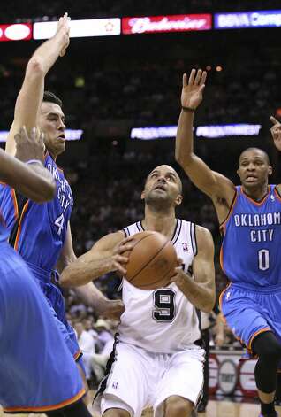 San Antonio Spurs' Tony Parker (9) shoots against Oklahoma City Thunder's Nick Collison (4) and Oklahoma City Thunder's Russell Westbrook (0) during the first half of game two of the NBA Western Conference Finals in San Antonio, Texas on Tuesday, May 29, 2012. Edward A. Ornelas/Express-News (Edward A. Ornelas / San Antonio Express-News) / SA