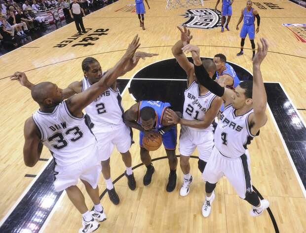 Oklahoma City Thunder's Kendrick Perkins (5) is under pressure from San Antonio Spurs' Boris Diaw (33), San Antonio Spurs' Kawhi Leonard (2), San Antonio Spurs' Tim Duncan (21) and San Antonio Spurs' Danny Green (4) during the first half of game two of the NBA Western Conference Finals in San Antonio, Texas on Tuesday, May 29, 2012. Edward A. Ornelas/Express-News (Edward A. Ornelas / San Antonio Express-News) / SA