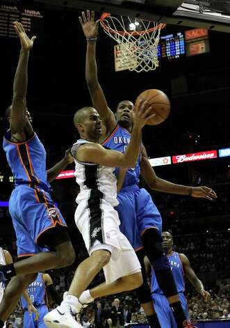 San Antonio Spurs' Tony Parker (9) passes around Oklahoma City Thunder's Kevin Durant (35) during the second half of game two of the NBA Western Conference Finals in San Antonio, Texas on Tuesday, May 29, 2012. Kin Man Hui/Express-News Photo: Kin Man Hui, San Antonio Express-News / Â© 2012 San Antonio Express-News