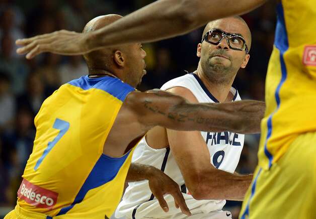 France's player Tony Parker, right, vies with Brazil's player Larry Taylor, during the basketball match France vs Brazil, in Strasbourg, eastern France, on July 21, 2012 as part of the preparation for the London 2012 Olympics. (Patrick Hertzog / AFP/Getty Images) / SA
