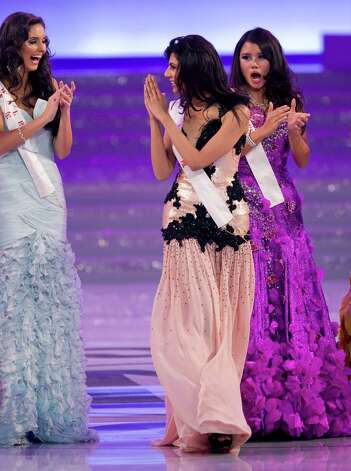 Miss Vanya Mishra of India, center, gestures as she walks on stage. Mishra won the Miss Multimedia and Beauty with a Purpose titles. Photo: AP / SL