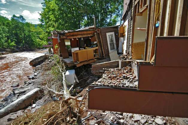 The swollen Batavia Kill swept away part of this house on Monday Aug. 29, 2011,  in Windham, NY, as a result of rain from Tropical Storm Irene  Eric Lenseth lived in the house, and got his aunt Anne Brabazon out before this two story  section was swept away.  (Philip Kamrass / Times Union) Photo: Philip Kamrass / AL