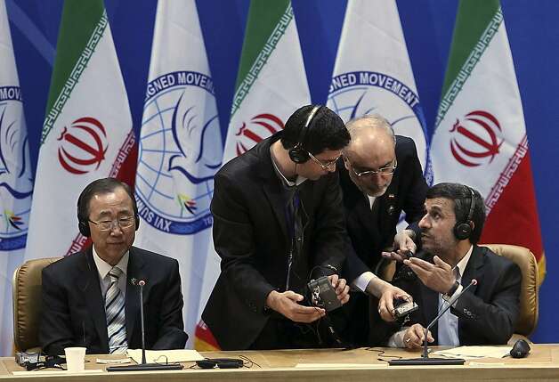 In this picture taken by semi-official Mehr News Agency, U.N. Secretary-General Ban Ki-Moon, left, looks on as Iranian President Mahmoud Ahmadinejad, right, confers with Foreign Minister Ali Akbar Salehi, center, and an unidentified man at summit of the Nonaligned Movement as  in Tehran, Iran, Thursday, Aug. 30, 2012. (AP Photo/Raouf Mohseni, Mehr News Agency) Photo: Raouf Mohseni, Associated Press / SF