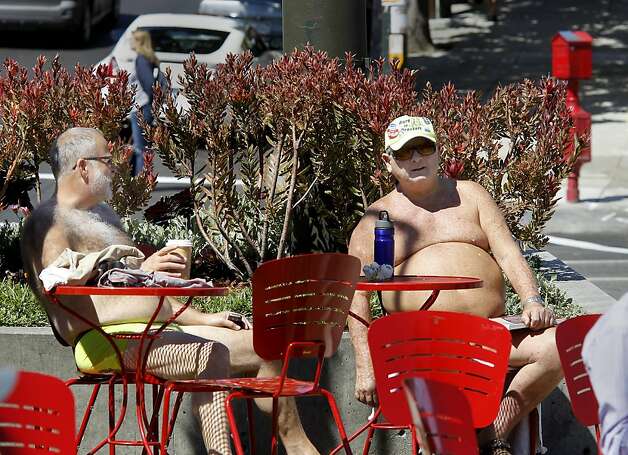 Dean W. (left), who still had his underwear on, and Ray soak up the sun in the plaza at Castro and Market streets. More people are finding S.F. public nudity objectionable. Photo: Brant Ward, The Chronicle / SF