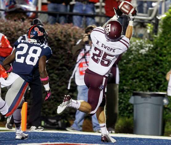 Texas A&M wide receiver Ryan Swope (25) reaches for a 20-yard touchdown reception against Mississippi  defensive back Mike Hilton (28) in the fourth quarter of an NCAA college football game in Oxford, Miss., Saturday, Oct. 6, 2012. Texas Af&M won 30-27. (AP Photo/Rogelio V. Solis) Photo: Rogelio V. Solis, Associated Press / AP