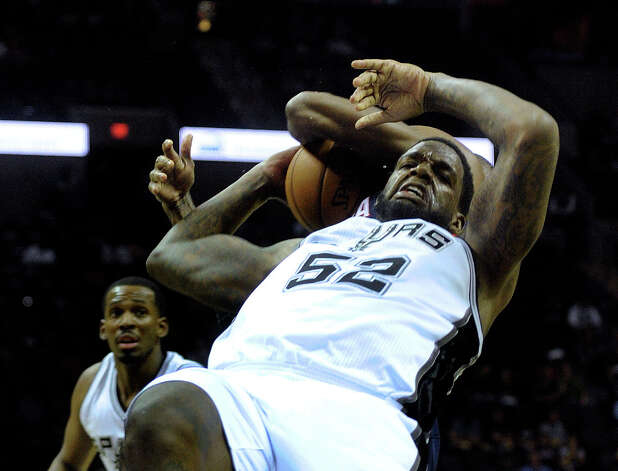 Spurs center Eddy Curry (52) gets tangled up with Josh Smith of the Atlanta Hawks during preseason NBA action at the AT&T Center on Wednesday, Oct. 10, 2012. Photo: Billy Calzada, San Antonio Express-News / ? San Antonio Express-News