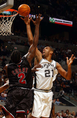 The Spurs' Tim Duncan goes over the Chicago Bulls' Eddy Curry during the first half at the SBC Center on Wednesday, Nov. 26, 2003. Photo: JERRY LARA, SAN ANTONIO EXPRESS-NEWS / SAN ANTONIO EXPRESS-NEWS