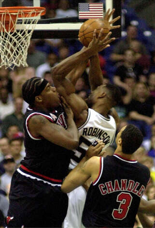 The Chicago Bulls' Eddy Curry (left) defends the Spurs' David Robinson as the Bulls' Tyson Chandler looks on during first period action at the Alamodome Thursday, March 14, 2001. Photo: DOUG SEHRES, SAN ANTONIO EXPRESS-NEWS / SAN ANTONIO EXPRESS-NEWS