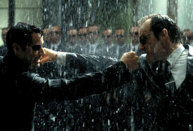 In the "Matrix" films, the intelligent machines have taken over, turning humans into an energy source and keeping them docile in a computer simulation of the world as it was in 1999, the year the first movie in the franchise came out. The main computer enforcer within this virtual world is Agent Smith (Hugo Weaving), right, shown fighting human hero Neo, played by Keanu Reeves. Photo: Warner Bros. Pictures / SL