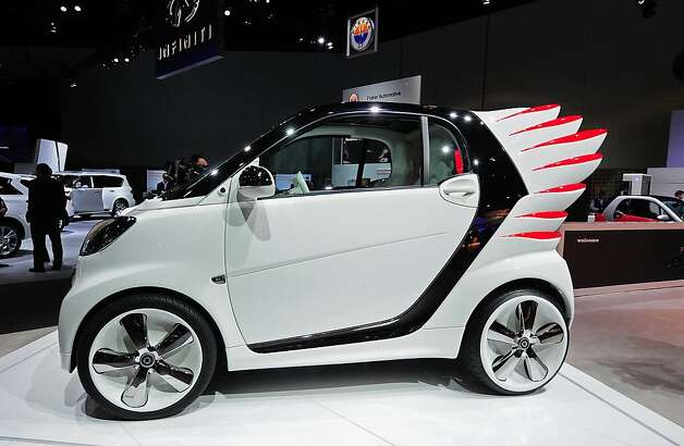 The winged "Smart forjeremy" special edition Smart Car from Daimler AG is unveiled at the Los Angeles Auto show  in Los Angeles on media preview day, November 28, 2012.  Smart forjeremy is the creation of fashion designer Jeremy Scott, who conceived of the special edition car with fiberglass wings which double as tail lights.  The LA Auto Show opens to the public on November 30 and runs through December 9. Photo: Robyn Beck, AFP/Getty Images / SF