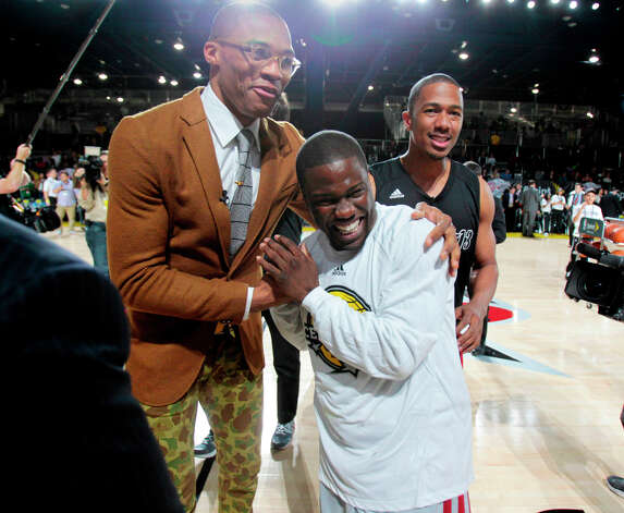 (l-r) Oklahoma City Thunder guard Russell Westbrook shares a laugh with comedian Kevin Hart ,and actor Nick Cannon during the 2013 Sprint All-Star Celebrity game. Photo: Billy Smith II, Houston Chronicle / © 2013 Houston Chronicle