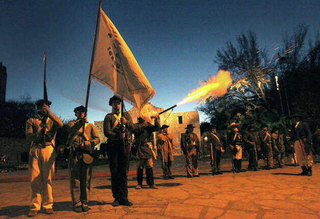 A member of the San Antonio Living History Association fires a musket (center) as others stand at attention Wednesday March 6, 2013 in front of the Alamo during the "Dawn at the Alamo" ceremony on the 177th anniversary of the battle for Texas independence. About 300 to 500 Mexican troops are said to have been killed or wounded in the battle and at least 189 Alamo defenders died in the battle or were executed. Photo: JOHN DAVENPORT, San Antonio Express-News / ©San Antonio Express-News/Photo Can Be Sold to the Public