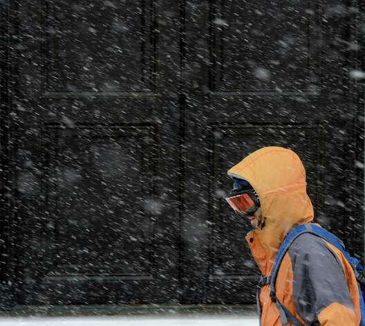An intrepid commuter walks in front of the Albany County Courthouse during a snow storm which has him protecting himself with ski goggles March 8, 2013, in Albany, N.Y.   (Skip Dickstein/Times Union) Photo: SKIP DICKSTEIN