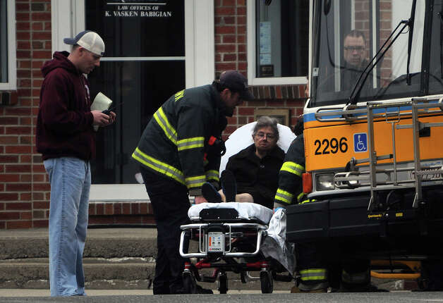 WATERTOWN, MA - APRIL 19: An elderly woman is evacuated from the School and Walnut streets area as police prepare to conduct a massive search for the one remaining suspect on April 19, 2013 in Watertown, Massachusetts. Earlier, a Massachusetts Institute of Technology campus police officer was shot and killed at the school's campus in Cambridge. A short time later, police reported exchanging gunfire with alleged carjackers in Watertown, a city near Cambridge. According to reports, one suspect has been killed during a car chase and the police are seeking another - believed to be the same person (known as Suspect Two) wanted in connection with the deadly bombing at the Boston Marathon earlier this week. Police have confirmed that the dead assailant is Suspect One from the recently released marathon bombing photographs. Photo: Darren McCollester, Getty Images / 2013 Getty Images