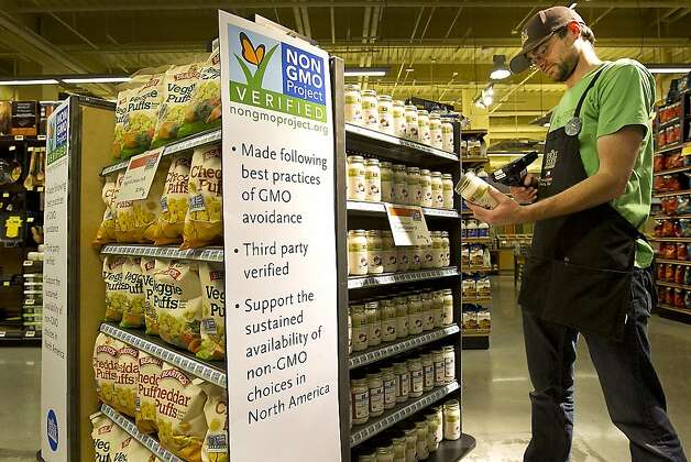 Ian Purdue scans non-GMO products at a Whole Foods Market in Austin, Texas. Photo: Ralph Barrera, McClatchy-Tribune News Service