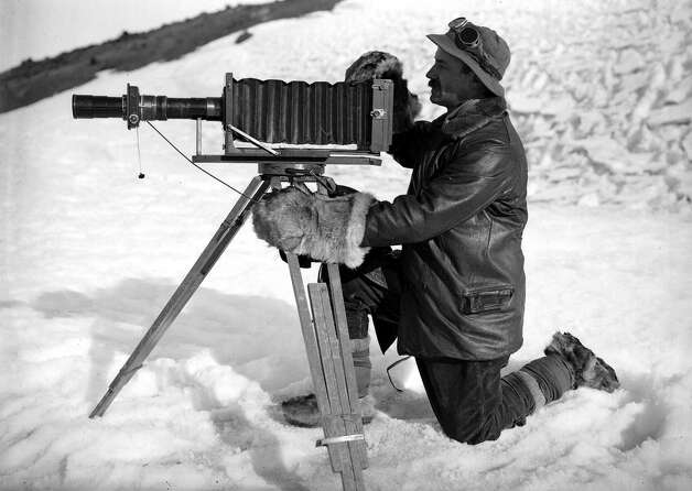 Full length portrait of photographer Herbert Ponting wearing warm clothing with his cinematograph. Photo: Popperfoto, H.G. Pointing/Terra Nova / Popperfoto