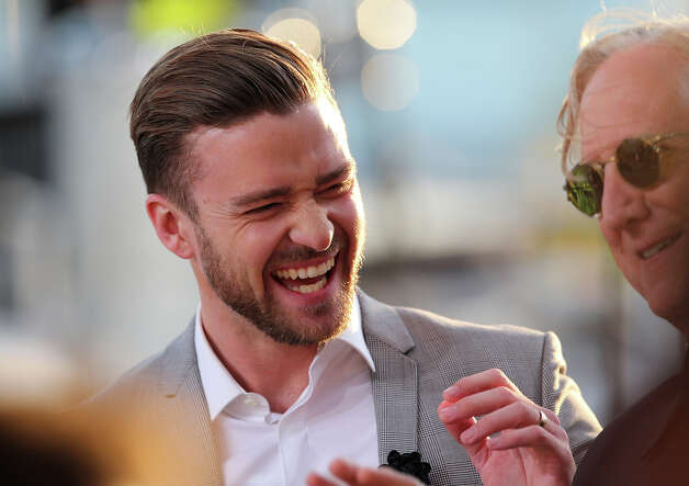 US actor and singer Justin Timberlake (L) laughs on May 20, 2013 with musician and producer T Bone Burnet as they take part in the show "Le Grand Journal" on the set of the French TV Canal+, on the sidelines the 66th Cannes film festival in Cannes. Cannes, one of the world's top film festivals, opened on May 15 and will climax on May 26 with awards selected by a jury headed this year by Hollywood legend Steven Spielberg. Photo: LOIC VENANCE, AFP/Getty Images / 2013 AFP