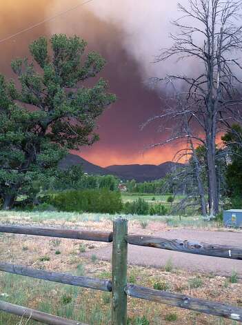 In this Thursday, June 20, 2013 photo provided by the U.S. Forest Service, wildfires fires approach the town of South Fork, Colo. The town of about 400 people was evacuated Friday morning, June 21, 2013.  Photo: Penny Bertram, Associated Press