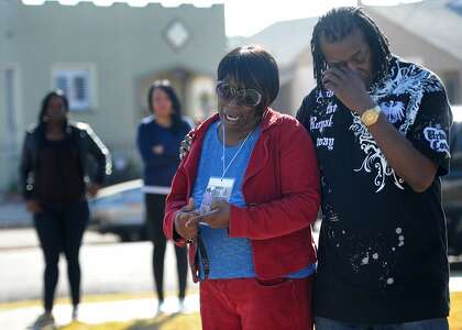 Dinyal New (left) and Freddie New are seen at the site (100th and Longfellow) in Oakland where Dinyal's son Lamar Broussard and his friend Derryck Harris were killed last night. New's other son  Lee Weathersby III was killed just weeks earlier on New Year's Eve. Photo: Susana Bates, Special to The Chronicle