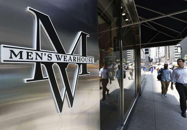 People pass by a Men's Wearhouse store in New York in this file photo takenJune 25, 2013.  Men's Wearhouse Inc raised its offer for Jos. A. Bank Clothiers Inc by over 10 percent, nearly two weeks after its smaller rival looked to fend off the unsolicited bid by agreeing to acquire Eddie Bauer.  REUTERS/Brendan McDermid/Files  (UNITED STATES - Tags: BUSINESS TEXTILE LOGO) Photo: Brendan Mcdermid, Reuters