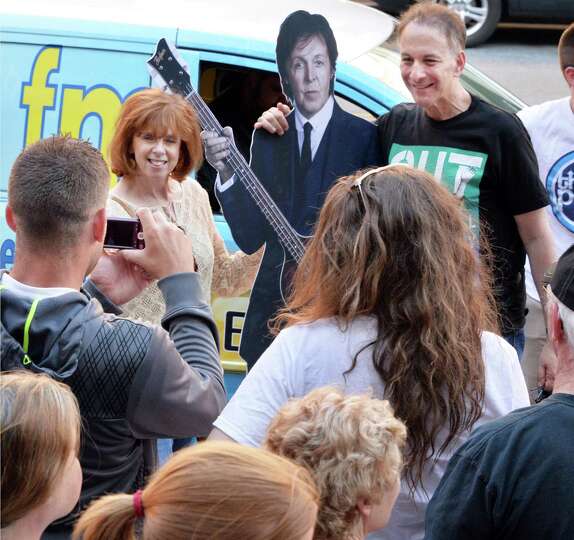 Fans takes turns being photographed with a Paul McCartney cut-out at the Times Union Center before t