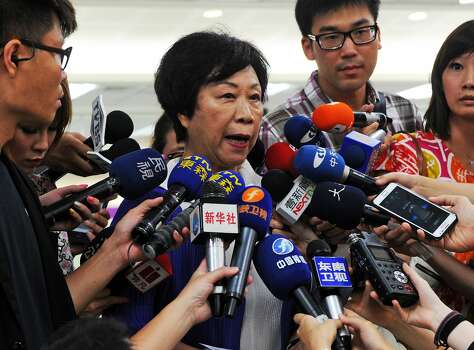 The Director of Taiwan's Civil Aeronautics Administration (CAA) Sheng Ching (second from left) speaks to media at the Sungshan airport in Taipei on July 23, 2014.   More than 40 people were killed in a plane crash in Taiwan, officials said, with local television reporting the flight had smashed into two houses after an aborted landing. Authorities said Taiwanese airline TransAsia Airways flight GE222, with 58 on board, crashed near Magong airport on the outlying Penghu island after having requested a second attempt to land. Photo: Sam Yeh, AFP/Getty Images