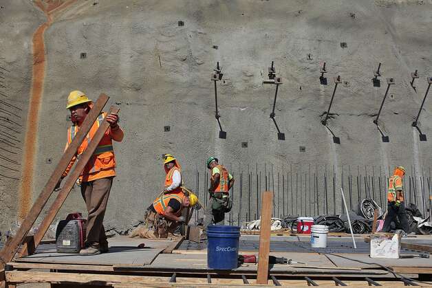 Construction crews work to build a spillway near the left abutment of the new Calaveras Dam near Fremont. The infrastructure project is part of a decade-old, $4.6 billion upgrade to the Hetch Hetchy water system. Photo: James Tensuan, The Chronicle