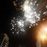 Fans set off fireworks after the Giants won the World Series in front of Willie Mays Plaza in San Francisco, Calif., on Wednesday, October 29, 2014.