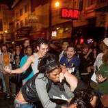 Two women fight in the middle of a Mission district street after the San Francisco Giants beat the Kansas City Royals to win the World Series on Wednesday, Oct. 29, 2014, in San Francisco. [AP Photo/Noah Berger)