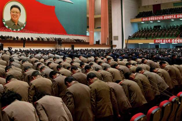 FILE - In this Dec. 16, 2012, file photo, North Korean military officers bow in front of an image of late North Korean leader Kim Jong Il during a national meeting of top party and military officials Pyongyang, North Korea, on the eve of the first anniversary of Kim's death. (AP Photo/Ng Han Guan, File) ORG XMIT: XWM412 Photo: Ng Han Guan / AP