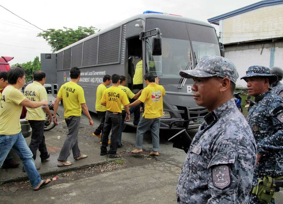 Muslim detainees board their bus to take them back to their detention following one of the reinvestigation hearings to review their cases at the the special court near their detention compound at Camp Bagong Diwa, Paranaque city, south of Manila, Philippines. In the country's dogged pursuit of terror suspects, Philippine law enforcers have made a slew of mistaken arrests. Photo: Jim Gomez / Associated Press / AP