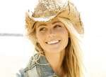 Hawaii, Kauai, Kealia, Beautiful young model poses on beach with cowboy hat. cowgirl blue jean woman happy smiling stock