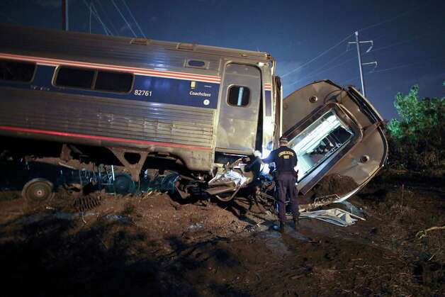 In this May 12, 2015 file photo, emergency personnel work the scene of a deadly train wreck in Philadelphia. Five years ago, federal safety officials proposed requiring video cameras in train cabs, but it didn't happen. That's left a gap as investigators try to unravel last week's fatal Amtrak derailment. Photo: Joseph Kaczmarek, AP Photo/ Joseph Kaczmarek/file / Associated Press